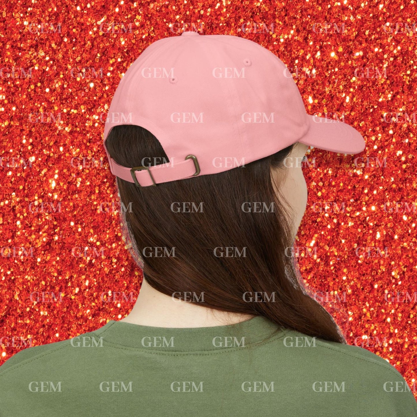 Person wearing a pink cap on a red glittery background