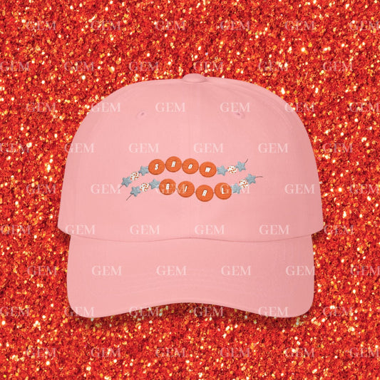 Pink cap with text and designs on a red glittery background
